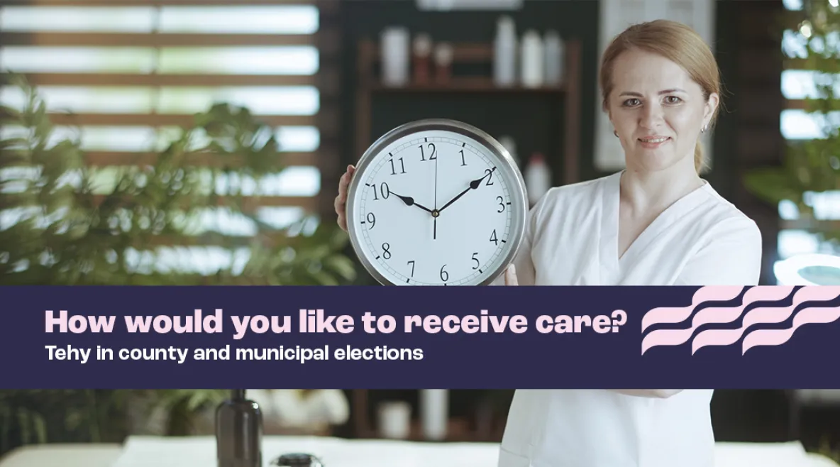 A nurse looks directly at the camera and shows a big clock she has in her hands. 