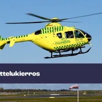 Kuvassa keltainen helikopteri ilmassa. 