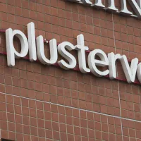 PlusTerveyden logo talon seinässä