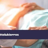 Vanhus makaa sängyssä, vierellä hoitajan kädet. 