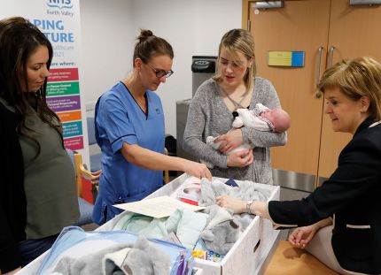 Pääministeri Nicola Sturgeon tutustuu äitiyspakkauksen sisältöön. 