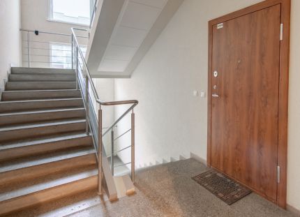 Rappukäytävä, jossa näkyy asunnon ovi ja portaat. Ensihoitajat joutuivat perääntymään rappukäytävään turvaan, kun potilas uhkasi heitä veitsellä Tampereella. 