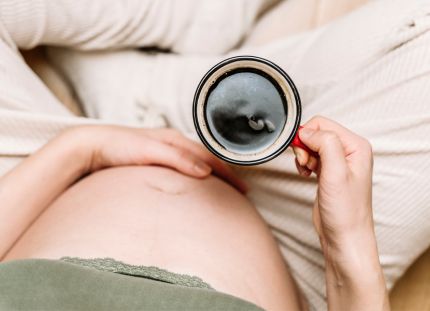 Raskaana oleva nainen juomassa kahvia kupista. Yksi kuppi kahvia riittää väitöksen mukaan raskaana olevalle.