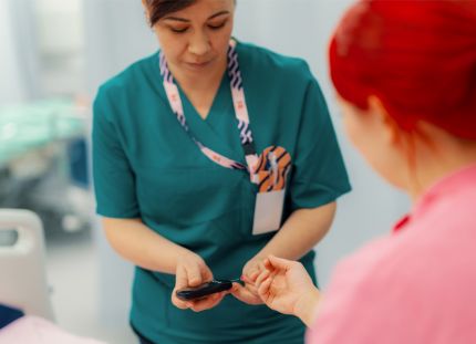 Sairaanhoitaja ottamassa pikanäytteen potilaan sormesta.